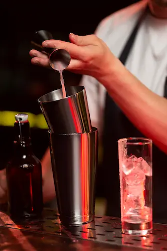 Consultant barman préparant un cocktail au shaker